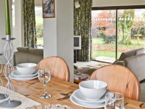 a dining room table with plates and glasses on it at The Waiting Rooms in Gaisgill