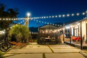 a house with a patio at night with lights at M-STYLE Shirako in Shirako
