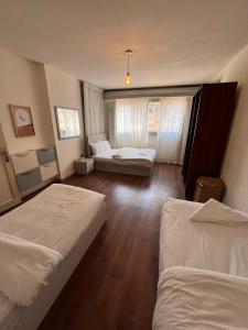 a hotel room with two beds and a window at Zamalek Jedda tower 3BR in Cairo