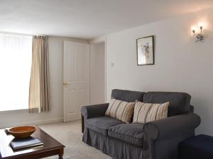 a living room with a couch and a table at Dove Cottage in South Hill