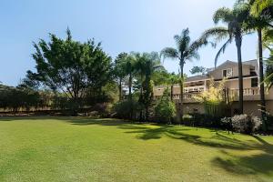 a large yard with palm trees and a building at Condomínio Vila Real - Villa de Luxo com Piscina in Itu