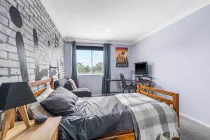a bedroom with a bed and a couch at 13 AMAROO in Port Macquarie +21 photos