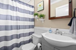 a bathroom with a sink and a toilet and a mirror at Whole Home 102 Madison Ter in Clarksville