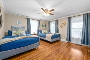 a bedroom with two beds and a ceiling fan at Whole Home 102 Madison Ter in Clarksville