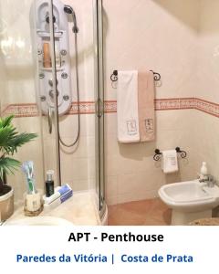 a bathroom with a shower and a toilet and a sink at BEACH ECO HOME Penthouse in Senhora da Vitória +53 photos