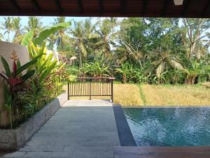a gate leading to a pool in a resort at Santika villa ubud in Ubud