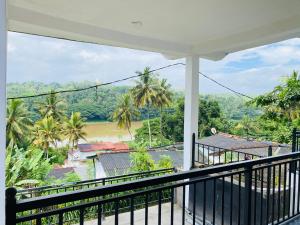 a balcony with a view of a river and trees at Top Notch by WASA in Kandy