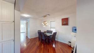 a kitchen and dining room with a table and chairs at Cozy comfy and relaxing home at Cougaridge SW Calgary in Calgary