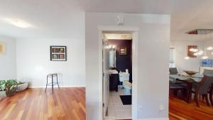a living room and a kitchen with a dining room at Cozy comfy and relaxing home at Cougaridge SW Calgary in Calgary