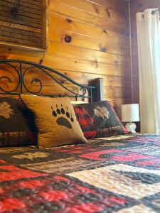 a bedroom with a bed with a dog paw pillow at Smores Retreat - Minutes from PF Parkway! Hot tub and fire pit! in Pigeon Forge