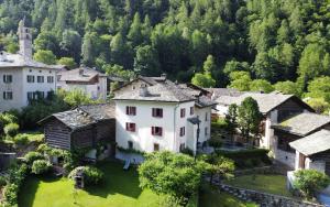 an aerial view of a village with a church at Bondo Bergell in Promontogno