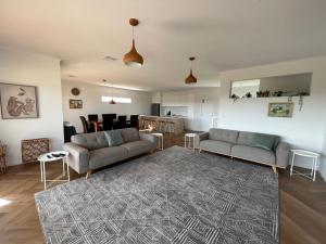 a living room with two couches and a rug at Mood Beach House - Moonta Bay in Port Moonta