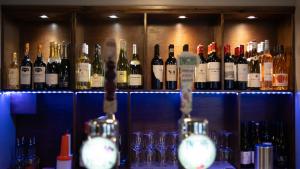 a bunch of bottles of wine sitting on a shelf at The Briery in Workington