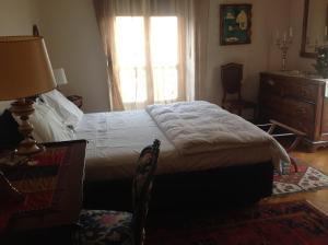 a bedroom with a bed and a dresser and a window at A Casa Armenia B&B in Turin