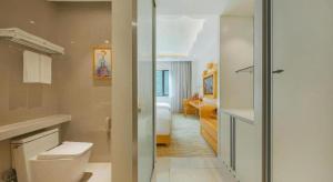 a bathroom with a toilet and a bedroom at Deefly Yinrun Town Hotel in Deqing +195 photos