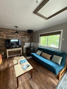 a living room with a blue couch and a table at Charming Private Casita in Flagstaff