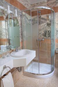 een badkamer met een wastafel en een douche bij Hotel Agora in Port de la Selva