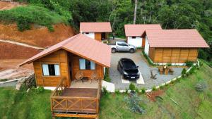 an aerial view of a house with a car parked in front at Chalés Mirante das Montanhas 