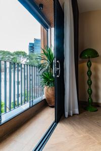 a door leading to a balcony with a potted plant at Anise Luxe Home in Ho Chi Minh City