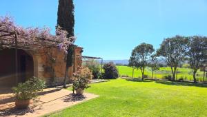 a garden with trees and grass and a building at Casa de campo en el Empordà in Cruïlles