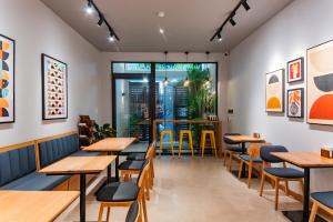 a restaurant with wooden tables and chairs at Anise Luxe Home in Ho Chi Minh City