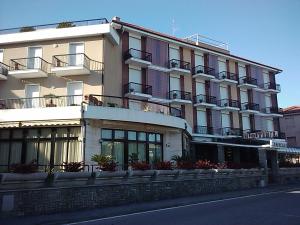 a large building on the side of a street at Hotel Liliana Andora citr 9006-0004 in Marina di Andora