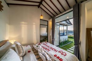 a bedroom with a bed and a large window at Mastaka Villa Kintamani in Kubupenlokan +131 photos
