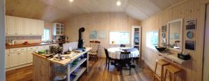 a kitchen with a table in the middle of it at Pourvoirie La Corneille in Havre-Saint-Pierre +18 photos