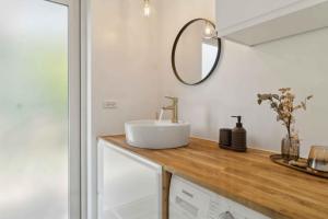 a bathroom with a sink and a mirror on a counter at New House Near Asserbo Plantation And Arresø in Frederiksværk +12 photos