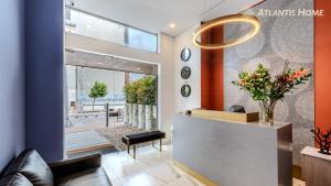 a lobby with a waiting room with a reception desk at Atlantis Home Suites Zona T in Bogotá
