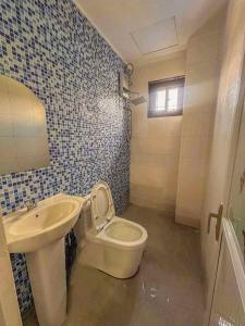 um banheiro com vaso sanitário e pia em Baguio De Bisita em Baguio