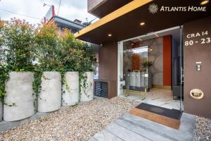 a store front with concrete planters in front of a store at Atlantis Home Suites Zona T in Bogotá +53 photos