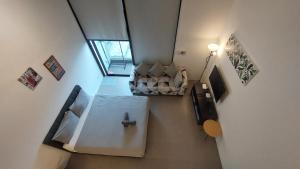 an overhead view of a living room with a couch at KL Sentral Loft, EST Bangsar #1, LRT in Kuala Lumpur