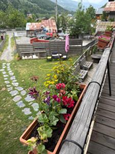 a garden with flowers on a wooden balcony at Casa Vitale Villard du Planay in Planay