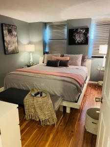 a bedroom with a large bed with a wooden floor at Welcome Home in Hyattsville