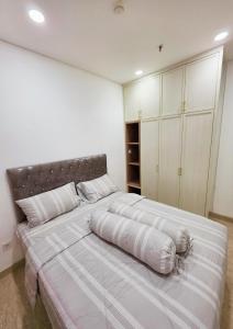 a large bed in a bedroom with white walls at Apartment - 2 bedroom, 3 beds in Medan