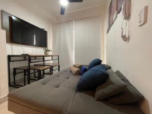 a large bed in a living room with a flat screen tv at Apto Completo na Chac Sto Antonio 7 min do Vibra SP in Sao Paulo