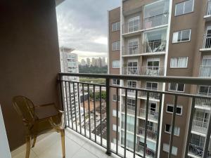a balcony with a chair and a view at Apto Completo na Chac Sto Antonio 7 min do Vibra SP in Sao Paulo
