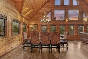 a dining room with a table and chairs at NEW Prime Cabin Hot Tub-Firepit-Safari Sleeps 8 in Broken Bow