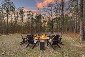 a group of chairs around a table with a fire at NEW Prime Cabin Hot Tub-Firepit-Safari Sleeps 8 in Broken Bow +55 photos