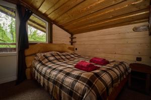 a bedroom with a bed with two red towels on it at Family Plai in Yaremche +100 photos