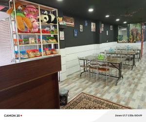 a dining room with tables and chairs and a restaurant at Periyar holidays in Thekkady