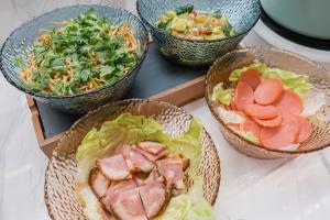 a table with three bowls of food on it at Atour Hotel Beijing Asian Games Village National Convention Center in Beijing