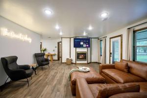 a living room with a couch and a fireplace at Casino Close Hot Tub-Firepit-BBQ 2-acres Sleeps 6 in Broken Bow