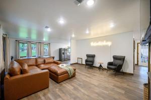 a living room with a brown couch and two chairs at Casino Close Hot Tub-Firepit-BBQ 2-acres Sleeps 6 in Broken Bow +56 photos