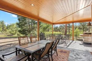a dining room with a table and chairs on a patio at Rock Creek Ranch in Show Low