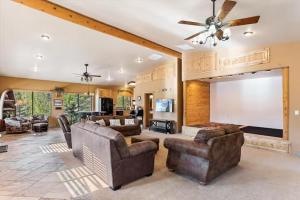 a large living room with couches and a projection screen at Rock Creek Ranch in Show Low
