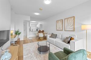 ブリスベンにあるModern Southbank Parklands Apartment Retreatの白いソファとテーブルのあるリビングルーム +19枚の写真