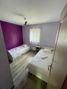a small room with two beds and a window at Maison familiale à Nantes Orvault in Orvault