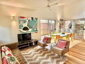 a living room with a couch and a table at Allure Stradbroke Resort in Point Lookout
